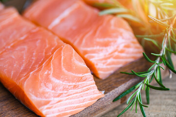 Fresh salmon fish on ice, Raw salmon filet with lemon rosemary herbs and spices