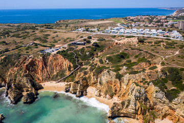 Camilo Beach in Lagos, Algarve - Portugal. Portuguese southern golden coast cliffs. Sunny day aerial view