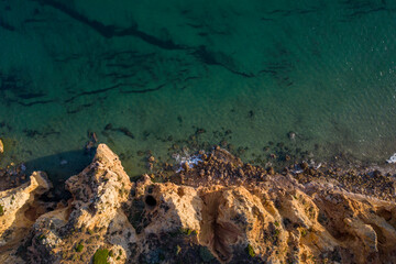 Fototapeta na wymiar Canavial Beach. Portuguese southern golden coast cliffs. Aerial drone top view in Lagos in Algarve, Portugal.