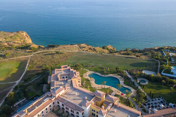 Fototapeta premium Canavial Beach. Portuguese southern golden coast cliffs. Aerial view over city of Lagos in Algarve, Portugal.