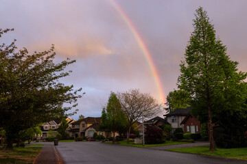 Street and Homes View at a Quite Residential Neighborhood in Suburban Area of a Modern City. Colorful Sunset Sky with Rainbow. Fraser Heights, Surrey, Greater Vancouver, BC, Canada.