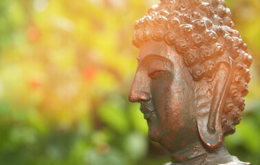 Buddha Statue in Outdoor Garden With Blurred Background