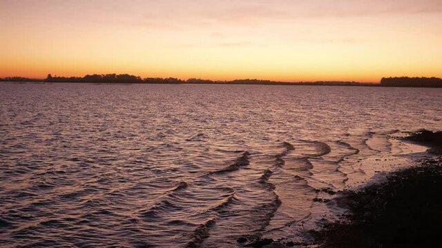 Beautiful Relaxing Landscape. Waves flowing at Dawn to the Banks of the Chascomus Lagoon, Argentina. Seamelss Loop.