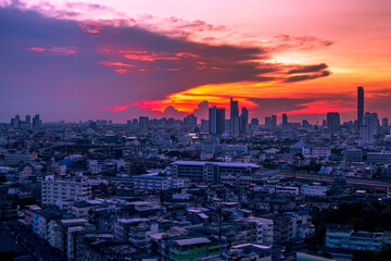 The blurred abstract background of the morning sun exposure to the tiny dust particles that surround the tall buildings in the capital, the long-term health issue of pollution.