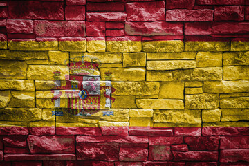 National flag of Spain on stone  wall background.The concept of national pride and symbol of the country. Flag  banner on  stone texture background.