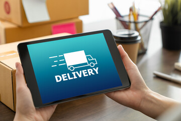 Startup small business, Young Asian woman holding digital tablet and showing delivery icon on screen.