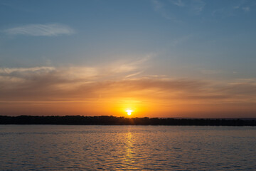 Fototapeta na wymiar Sunset sun across the river