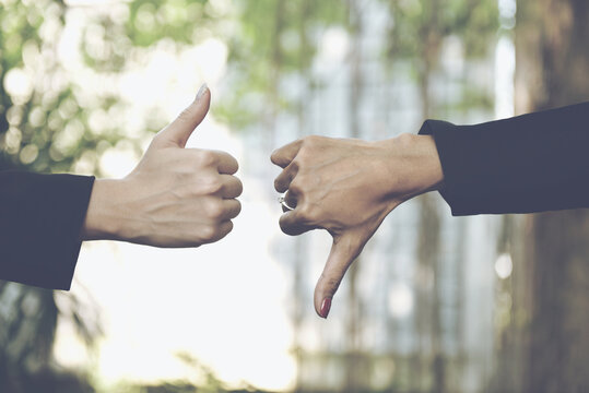 Successful businesswomen  showing thumbs up and down