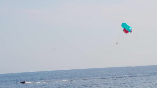 Scenic parasailing captured from the side. Ocean activity,