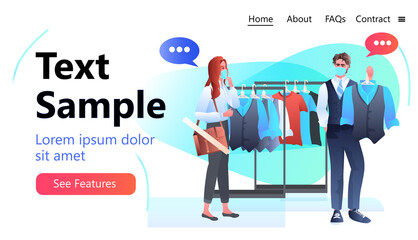 salesman in mask showing clothes to female customer in fashion boutique coronavirus pandemic quarantine concept