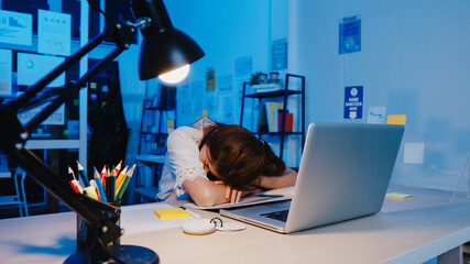 Freelance Asia exhausted lady hard work sleeping at new normal home office. Working from house...