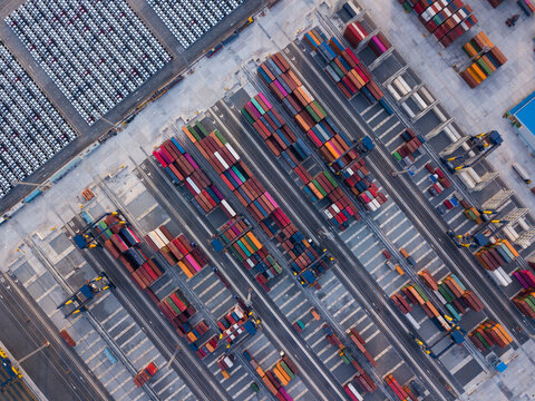 Aerial drone view above containers at dockyard. Professional business logistics and transportation of cargo ship.