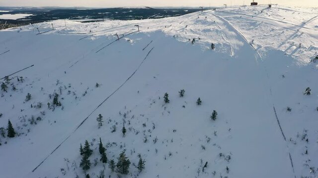 Aerial view overlooking the Olostunturi slopes, in Lapland - tilt, drone shot