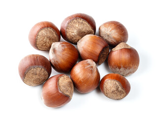 handful of unshelled hazelnuts closeup on white