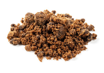pile of dark muscovado sugar closeup on white