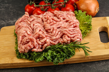 Raw pork minced meat over board