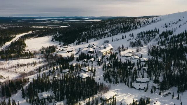 Aerial view around the Olostunturi ski center and slopes, in Lapland - orbit, drone shot