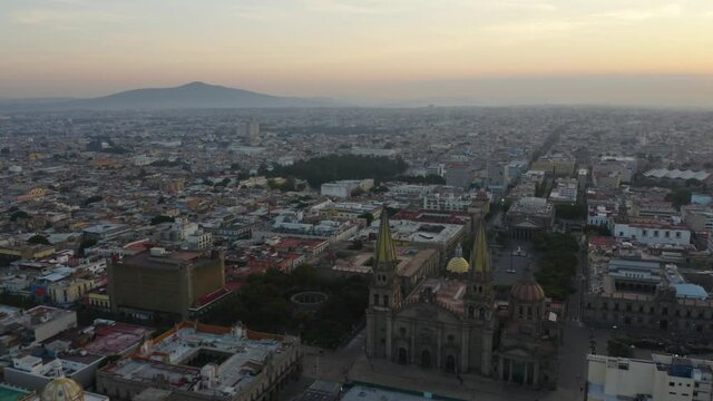 Aerial Shot Above Guadalajara with Famous Cathedral below at Sunset