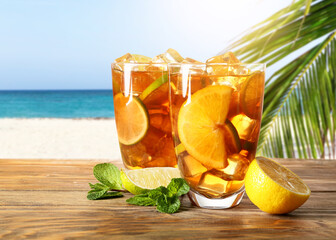 Glasses of tasty cold ice tea on table in beach bar