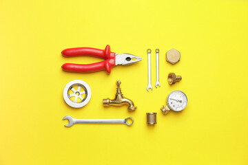 Set of plumber's items on color background
