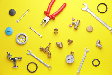 Set of plumber's items on color background