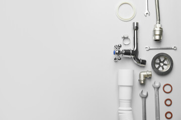 Set of plumber's items on light background