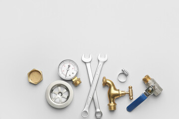 Set of plumber's items on light background