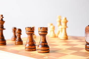 Game board with chess pieces on light background