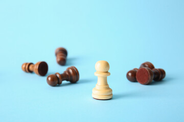 Wooden pawns on color background