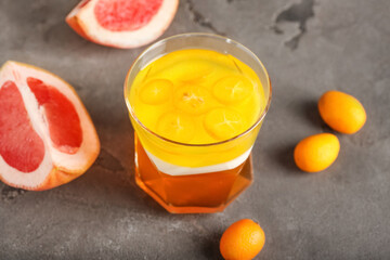 Glass of tasty jelly on grey background