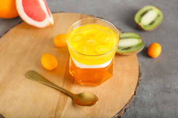 Glass of tasty jelly on grey background