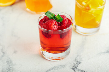 Glasses of tasty jelly on light background