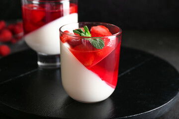 Glasses of tasty jelly on dark background