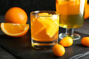 Glasses of tasty citrus jelly on dark background