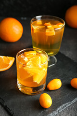 Glasses of tasty citrus jelly on dark background