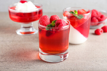 Glasses of tasty jelly on grey background