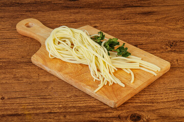 Chechil spaghetti cheese over board