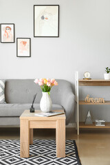 Interior of modern living room with tulip flowers