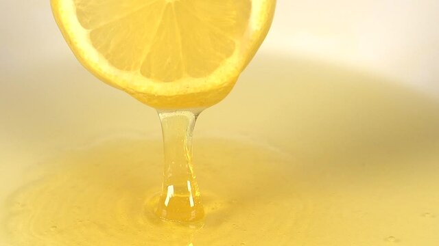 Honey drips from a lemon