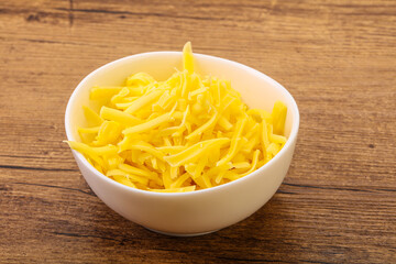 Shredded yellow cheese in the bowl