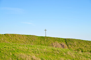 Fototapeta na wymiar Landscape cross on a mountain in a meadow