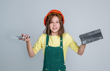 labor day. plasterer. teen girl in uniform and helmet. female builder in hard hat.
