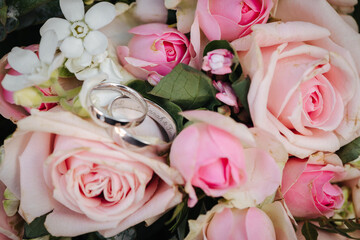 Wedding rings close up with flowers