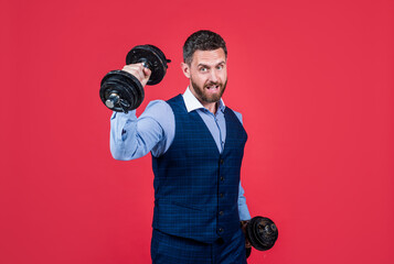 Strong man businessman do dumbbell workout red background, business strength