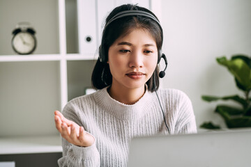 Attractive woman in casual wear wearing headset working telephone operator support data to customer at home, call center, advisor, hotline, video call, marketing, telecom business concept