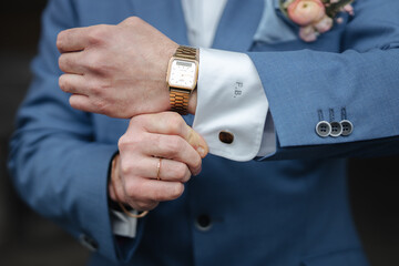 Groom showing his cufflinks