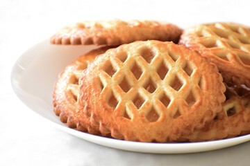 Mini apple tarts with apple filling on a white plate.