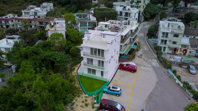 Ariel Drone dolly push out over village house Sai Kung Hong Kong. Revealing rural village estate pull back HD 4k Drone shot.