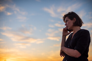 Woman seen talking on her cellphone shot from low angle