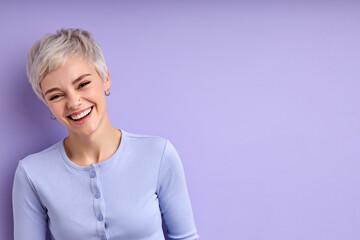 Excited woman with short hair laughing, feeling happiness, have fun. Caucasian young adult female in casual shirt posing at camera, having perfect toothy smile. Human emotions concept